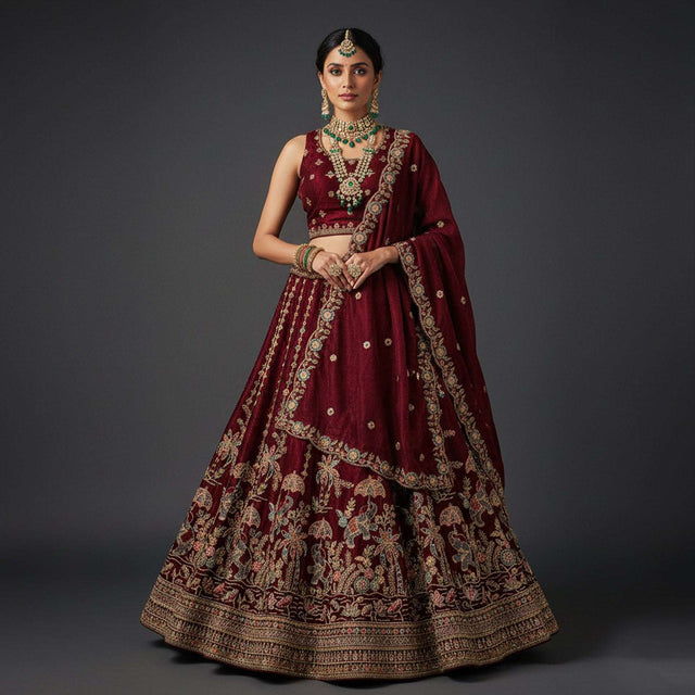 Maroon tissue silk lehenga with gold zari and floral embroidery, wide flared skirt