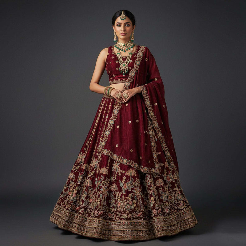Maroon tissue silk lehenga with gold zari and floral embroidery, wide flared skirt