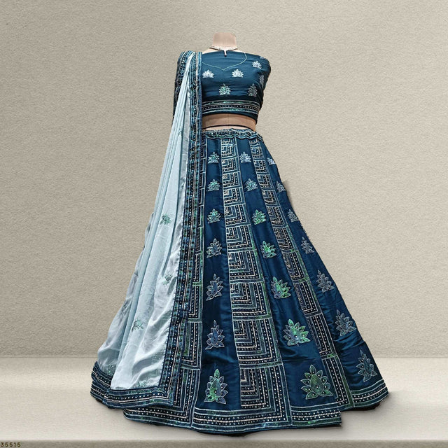 Back view of navy blue lehenga with teal georgette drape, ornate border and motifs