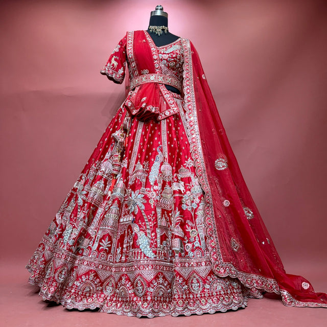 Red raw silk bridal lehenga set with blouse and two dupattas on mannequin