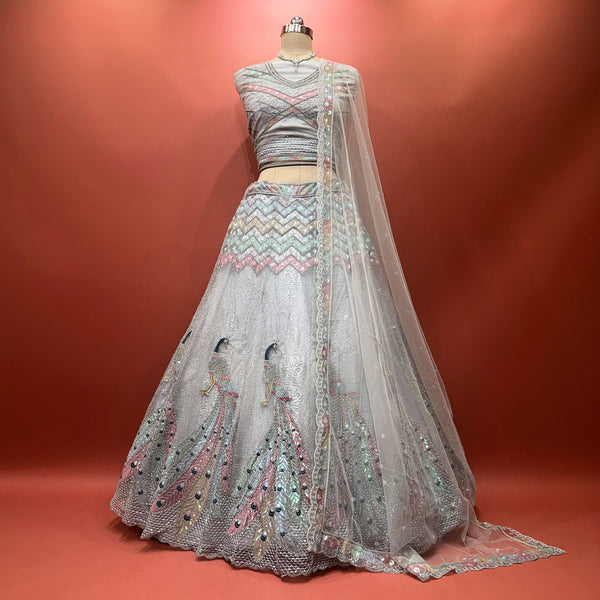 Grey net lehenga with peacock motif, sequined bodice and flared skirt