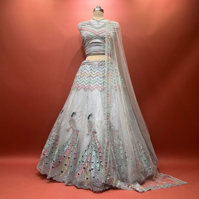 Grey net lehenga with peacock motif, sequined bodice and flared skirt