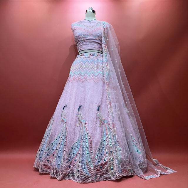 Soft pink net lehenga with peacock motif embroidery and sheer drape dupatta