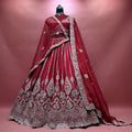 Cherry bridal lehenga on mannequin with double dupatta and silver embroidery hem