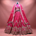 Rani pink raw silk bridal lehenga with pearl jhumar motifs, floral resham hem and double dupatta draped as a veil