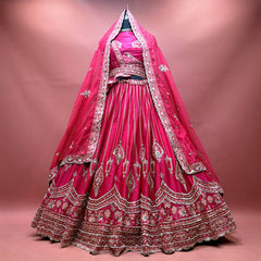 Rani pink raw silk bridal lehenga with pearl jhumar motifs, floral resham hem and double dupatta draped as a veil