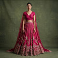 Fuchsia pink bridal lehenga with embroidered border and draped double dupatta