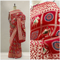 Red silk saree with decorative patchwork motifs and border, draped on mannequin.