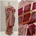 Maroon silk saree with gold weave, ornate border and geometric block pattern.