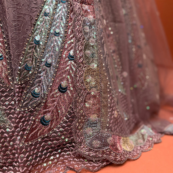 Mauve net lehenga skirt with peacock motif sequins and beadwork, layered hem
