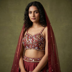 Maroon raw silk lehenga set with mirror-and-bead work, blouse, and sheer dupatta
