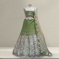 Green sequined lehenga with silver floral pattern hem and sheer net dupatta