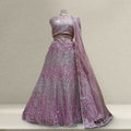Pink sequin net lehenga with matching dupatta, sleeveless blouse and flared skirt