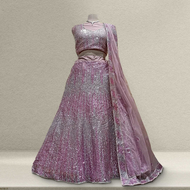Pink sequin net lehenga with matching dupatta, sleeveless blouse and flared skirt