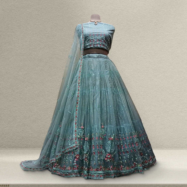 Teal lehenga set with flared skirt, embroidered hem, and sheer dupatta