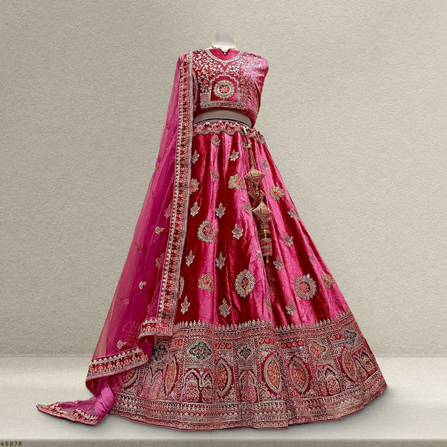 Magenta velvet lehenga skirt with ornate silver embroidery and patterned border