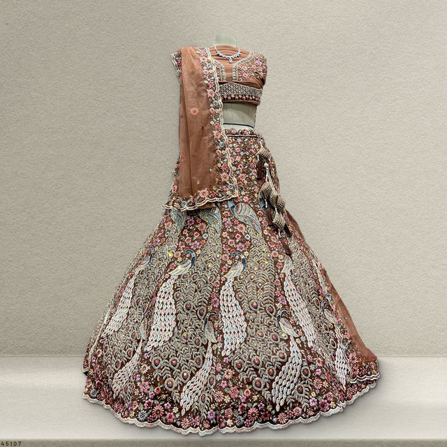 Rust peacock-embroidered lehenga with cropped blouse and floral border