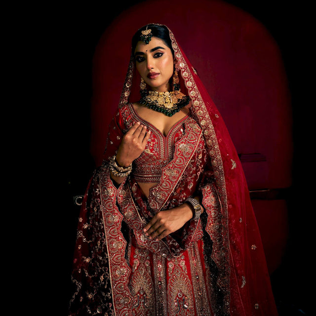 Red bridal lehenga set with ornate chest detailing, matching dupatta and skirt