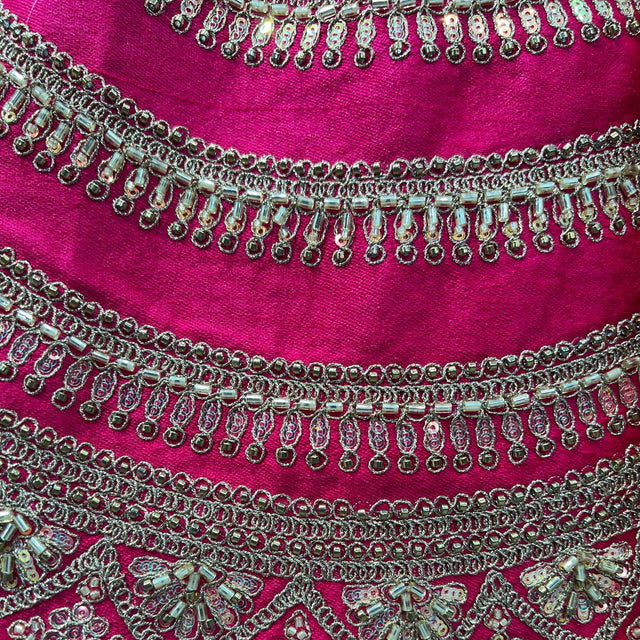 Pink lehenga hem with gold bead embroidery and scalloped chain trim