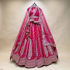 Rani pink bridal lehenga with double sheer dupattas and ornate silver embroidery