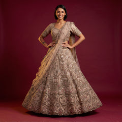 Champagne bridal lehenga dress with full skirt, long sleeves, and palace embroidery