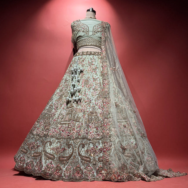 Sage green net bridal lehenga with ornate palace embroidery and matching sheer dupatta