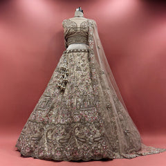 Champagne net bridal lehenga with ornate palace-style embroidery and sheer dupatta