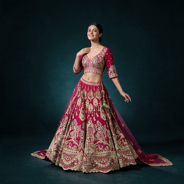 Rani pink bridal lehenga with gold embroidery, short blouse, and double dupatta