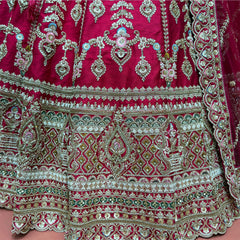 Close-up of the lehenga hem with stacked bands of diamond lattice, paisley arches, scalloped borders and bead, cutdana and zari work in gold, ivory and olive green