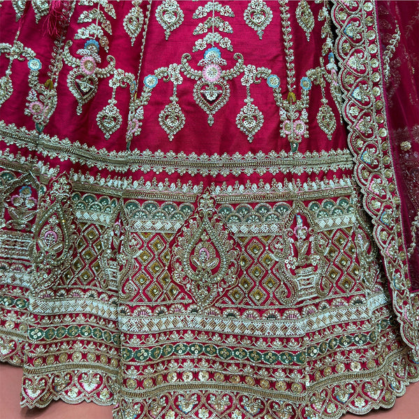 Raspberry tiered skirt hem with dense multicolor embroidery and decorative border trims