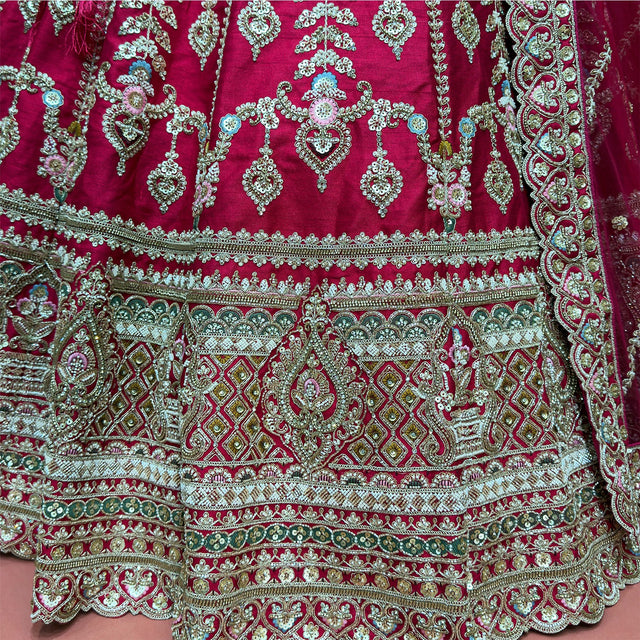 Close-up of the lehenga hem with stacked bands of diamond lattice, paisley arches, scalloped borders and bead, cutdana and zari work in gold, ivory and olive green