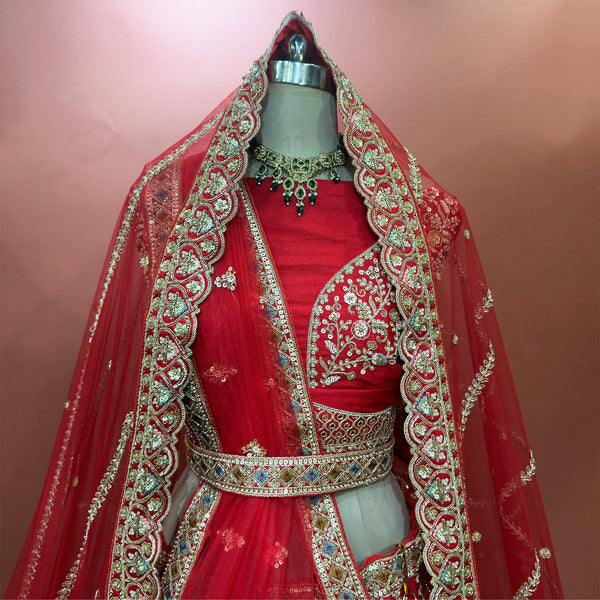 Red net dupatta with gold-toned embroidered border over bridal blouse and lehenga