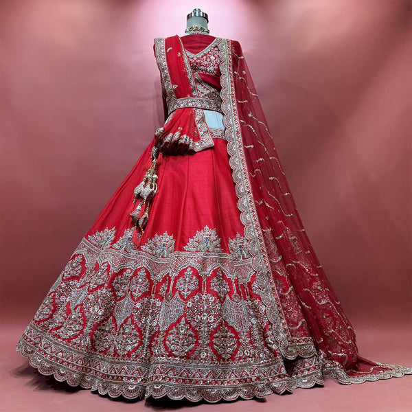 Red bridal lehenga with embroidered back bodice, flared fan hem, and net dupatta