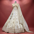 Ivory lehenga skirt with ornate gold-toned embroidered motifs and scalloped hem