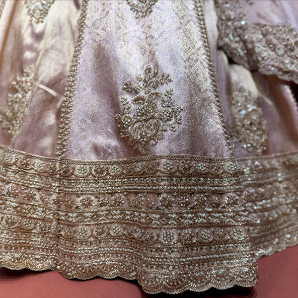 Baby pink lehenga with gold embroidered border and floral kali motif on skirt