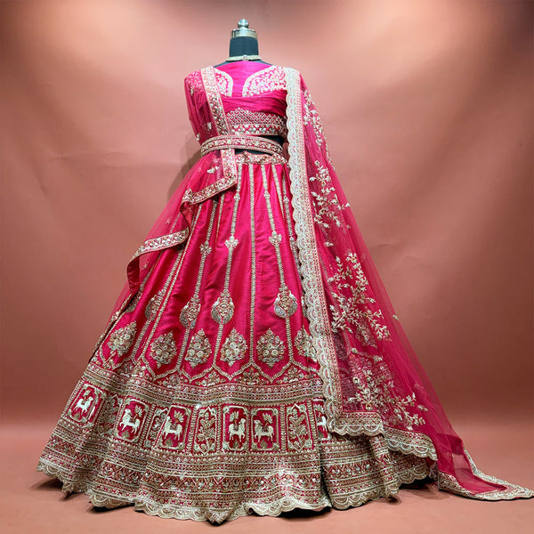 Rani pink bridal lehenga in raw silk with gold border and net dupatta