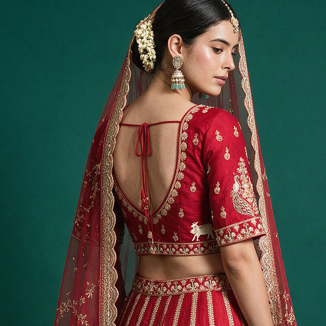 Red bridal lehenga back tie blouse with gold trim and gold-bordered double net dupatta