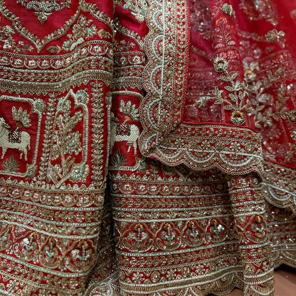 Red lehenga skirt and bodice with heavy gold embroidery and decorative border