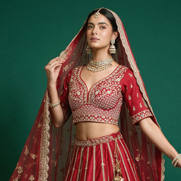Red bridal lehenga with embellished crop blouse and gold-bordered double net dupatta