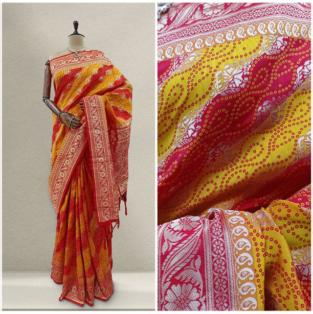 Designer silk saree draped on mannequin, red-orange and yellow bandhej pattern with border