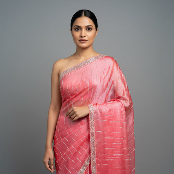 Coral tissue saree with silver sequin lines and embellished border