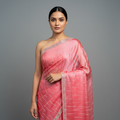 Pink party saree with silver border and subtle geometric weave, one-shoulder drape