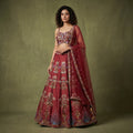 Maroon raw silk lehenga skirt with ornate mirror-and-bead embroidery and sheer dupatta