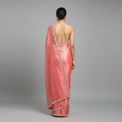 Pink saree with silver zari border and all-over geometric weave, back view drape