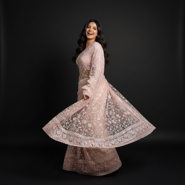 Light pink net saree with flared skirt-like pallu and embellished border