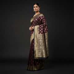 Maroon woven saree with gold zari border and scattered gold motifs, tasselled end