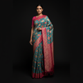 Teal saree with pink placement prints, contrast pallu, and long draped fall