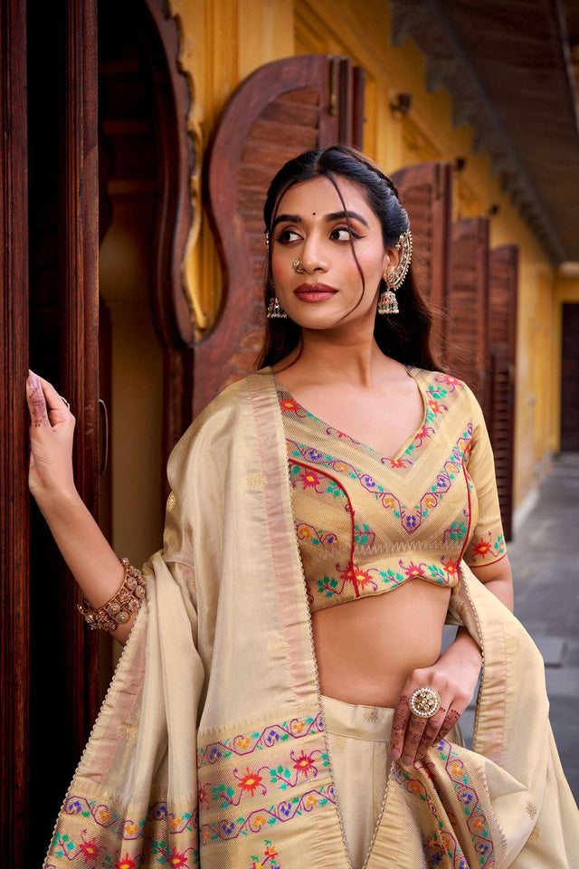 Cream blouse and lehenga with multicolor floral embroidery; draped cream dupatta