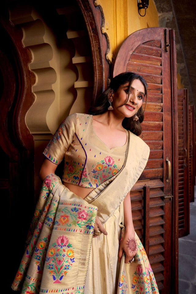 Cream choli and lehenga with multicolor floral embroidery, draped dupatta, tassel trim