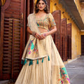Cream lehenga choli with floral embroidery, green tassel-edged dupatta
